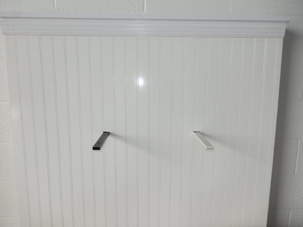 An installed black and white concealed flat bracket